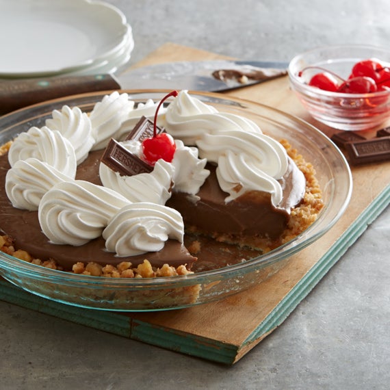 A Cake with cream and cherry at the top